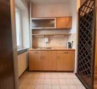Kitchen unit with ceramic tile flooring and wooden decor in warehouses and halls.