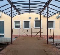 Shelter with a metal structure near a building in Banská Bystrica, warehouses and halls.