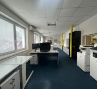 Office space with carpet, desks, monitors, and copiers.