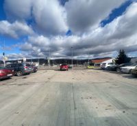 Parking lot with cars and cloudy sky in Žiar nad Hronom, Žiar nad Hronom District.