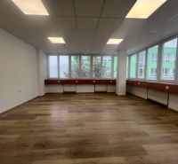 Offices with wood-patterned flooring and large windows, Banská Bystrica.