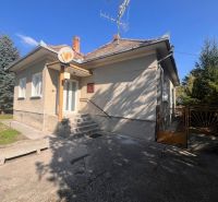 A family house in Vrakúňa with stairs in front of the entrance and a simple yard.