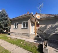 A family house in Vrakúň with a lawn, satellite, and antenna on the roof.