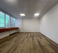 Offices with large windows and wooden decor flooring.