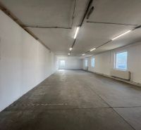 A large empty hall with a concrete floor in the building Warehouses and Halls.