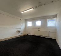 Empty room in warehouses and halls with windows, a sink, and a radiator.