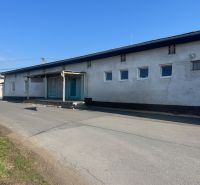 Warehouses and halls in the Banská Bystrica district, a concrete building on the road.