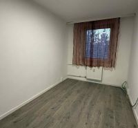 A room in a 4-room apartment with a wooden decor floor and a simple curtain.