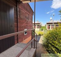 In Nové Zámky, a cottage with a garden, wood-paneled, with railings and satellites.