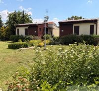 Two cottages in Nové Zámky surrounded by a landscaped garden and greenery.