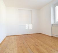 An empty room with a wooden decor floor in a family house.