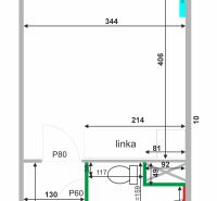 Layout of a studio apartment with a kitchenette and a bathroom containing a washing machine and a toilet.