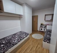 Children's room with wood decor flooring and built-in wardrobes in a 3-room apartment.