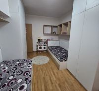 Children's room with beds and wooden decor flooring in a 3-room apartment.