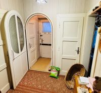 Carpeted floor, doors, and decorations in the interior of a 3-room apartment.