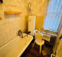 A bathroom with a bathtub and a boiler in a 3-room apartment.