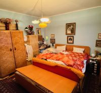 A bedroom in a 3-room apartment with vintage furniture and decor.