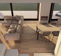 Interior view of a living room with a sofa, coffee table, and wooden decor flooring.
