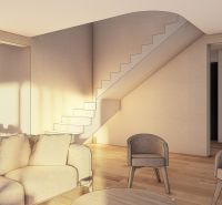 Living room with wood-patterned flooring, staircase, and comfortable seating.