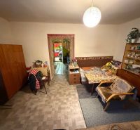 Living room in a family house with antique furniture and armchairs, floor with wooden decor.