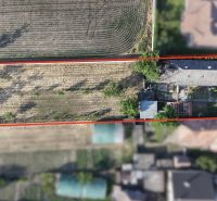 Aerial view of a family house complex in Nesvady with an adjacent plot of land.