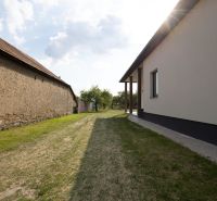 A view of the backyard of a family house in Zemplínska Široká with grass cover.