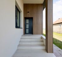 Entrance area in a family house in Zemplínska Široká with a wooden facade decor.
