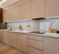A kitchen in a family house with wooden decor and marble tiles.