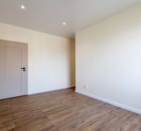 Interior of a family house with a wooden decor floor and light walls.