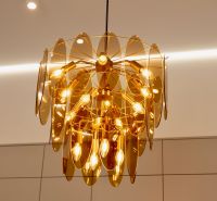 A golden chandelier in the interior of a family house adorns the room with its unique design.