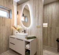 Bathroom with an oval mirror and natural tones, floor with wood decor.