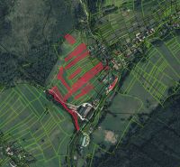 An aerial map of agricultural and forest lands around the village of Nová Bystrica.
