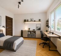 A bedroom with a bed, a desk, and a wooden decor floor in a 3-room apartment.