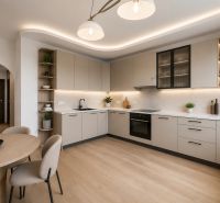 A kitchen in a 3-room apartment with a kitchen unit and a wooden decor floor.