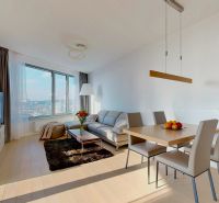 Bright living space with a comfortable sofa, dining table, and a view. 3-room apartment.