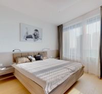 Bedroom in a 3-room apartment with a bed, curtains, and a floor with a wooden decor.
