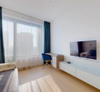 Living room with a sofa, desk, television, and wooden decor flooring in a 3-room apartment.