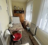Room in a family house with carpet, furniture, and decorations.