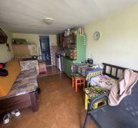 Living room in a family house with a wooden decor floor and colorful furniture.
