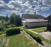 A family house in Orlov with a garden and a manicured lawn in sunny weather.