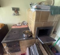 Traditional solid fuel kitchen stove in a family house with rustic decor.