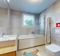 Bathroom in a 3-room apartment with patterned tiles, a bathtub, and a window.