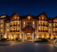 A night scene of a hotel in beautiful illumination with stars in the sky.