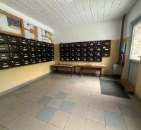 The interior entrance with mailboxes and bulletin boards of a 2-room apartment.