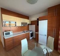 A kitchen in a 3-room apartment with a wooden decor and modern equipment.
