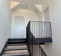 A staircase with a metal railing in a 2-room apartment, minimalist style.