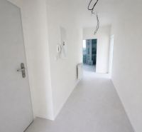 A hallway in a 2-room apartment with white walls and an empty interior.