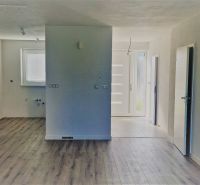 Interior of a family house with a wooden decor floor and light walls.