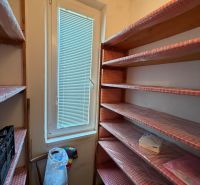 Storage space with shelves and a window, ideal for a 2-room apartment.