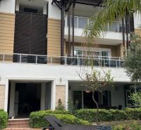 Building with glass balconies and greenery in Side, Turkey - Unique properties.